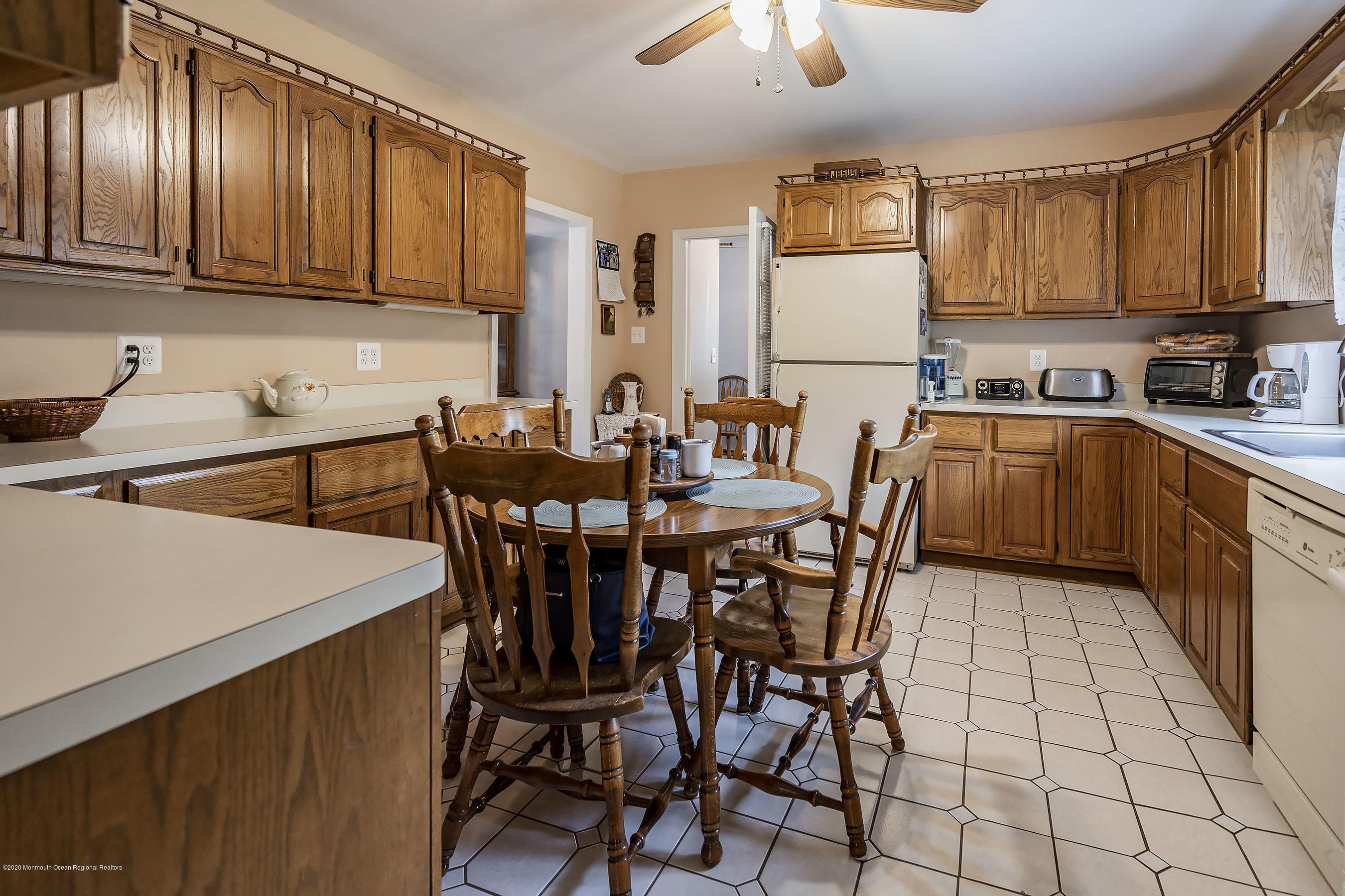 7 Wooleytown Road Morganville, NJ 07751 - Photo 12 of 30 a kitchen with stainless steel appliances granite countertop a table chairs sink and cabinets