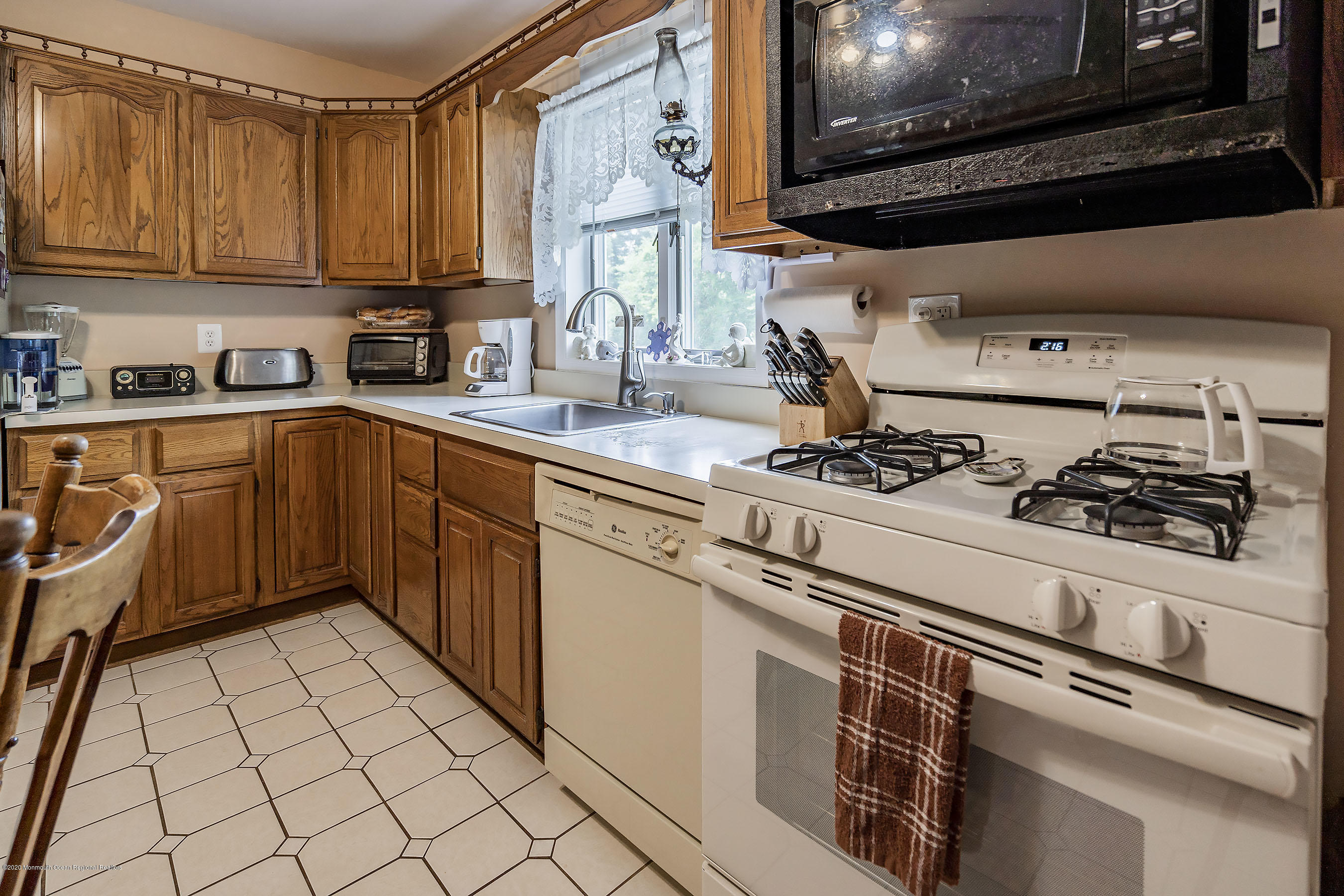 7 Wooleytown Road Morganville, NJ 07751 - Photo 13 of 30 a kitchen with stainless steel appliances a sink a stove and cabinets