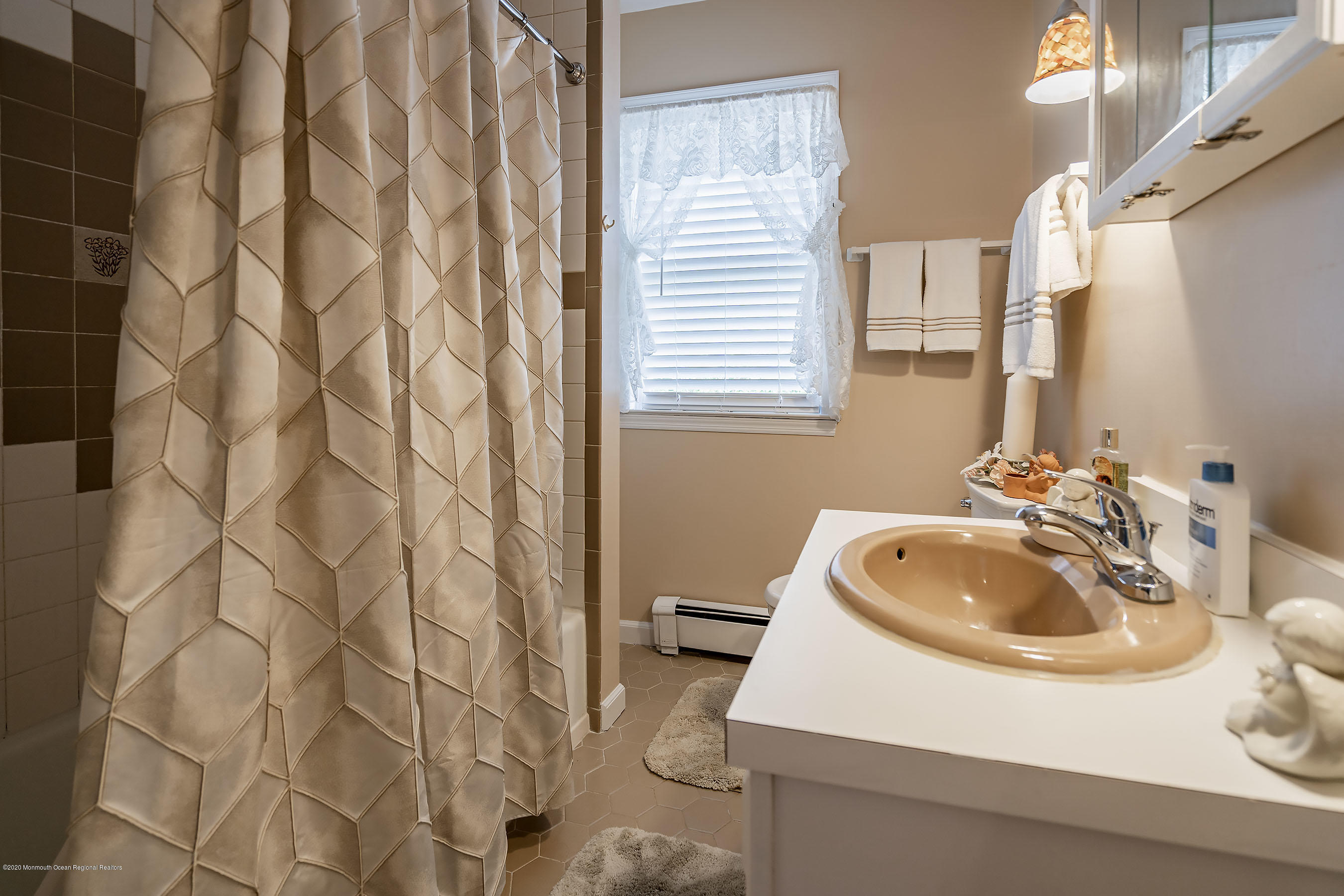7 Wooleytown Road Morganville, NJ 07751 - Photo 21 of 30 a bathroom with a sink and a mirror