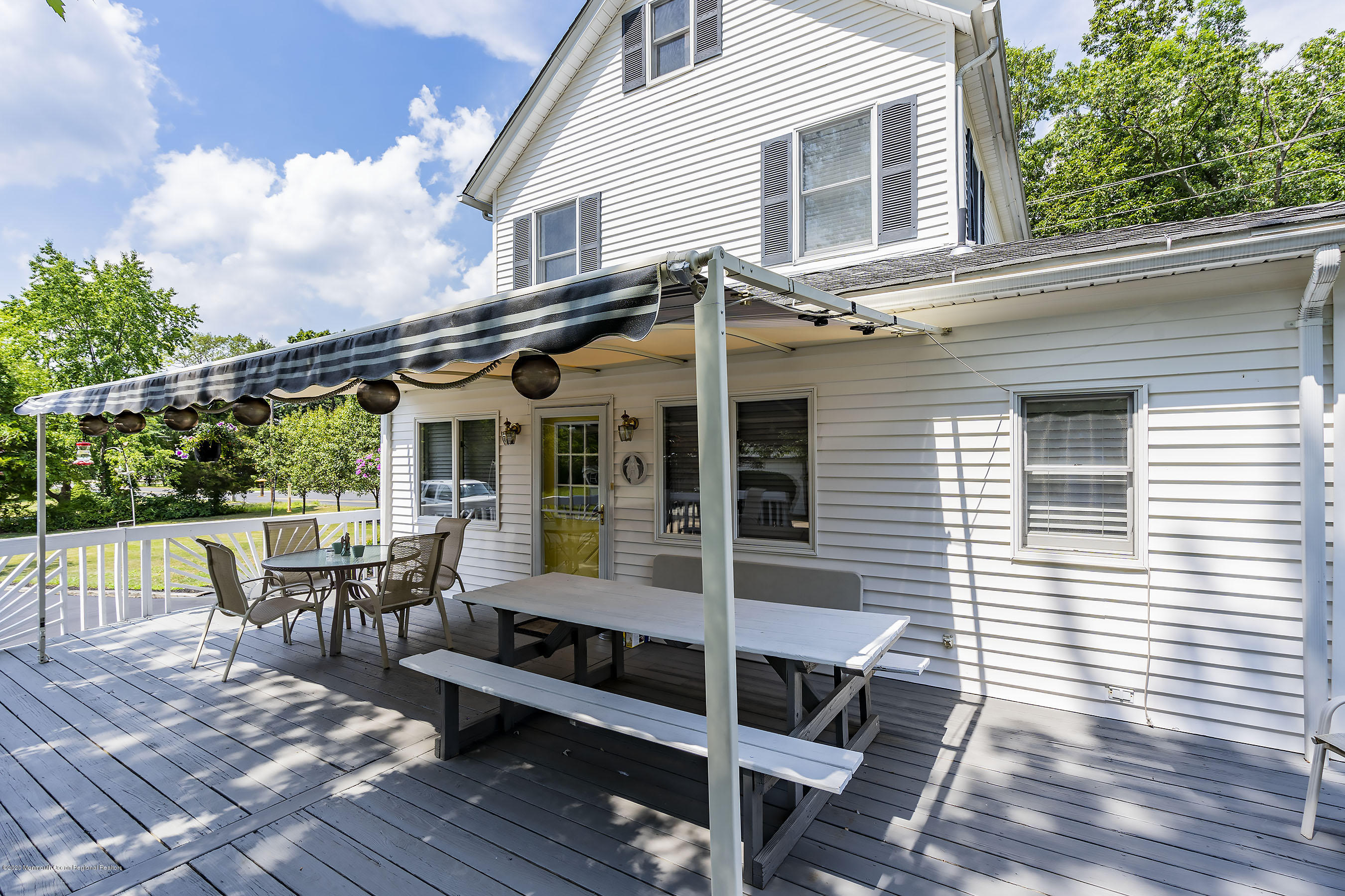 7 Wooleytown Road Morganville, NJ 07751 - Photo 23 of 30 a view of a patio with table and chairs with wooden floor and fence