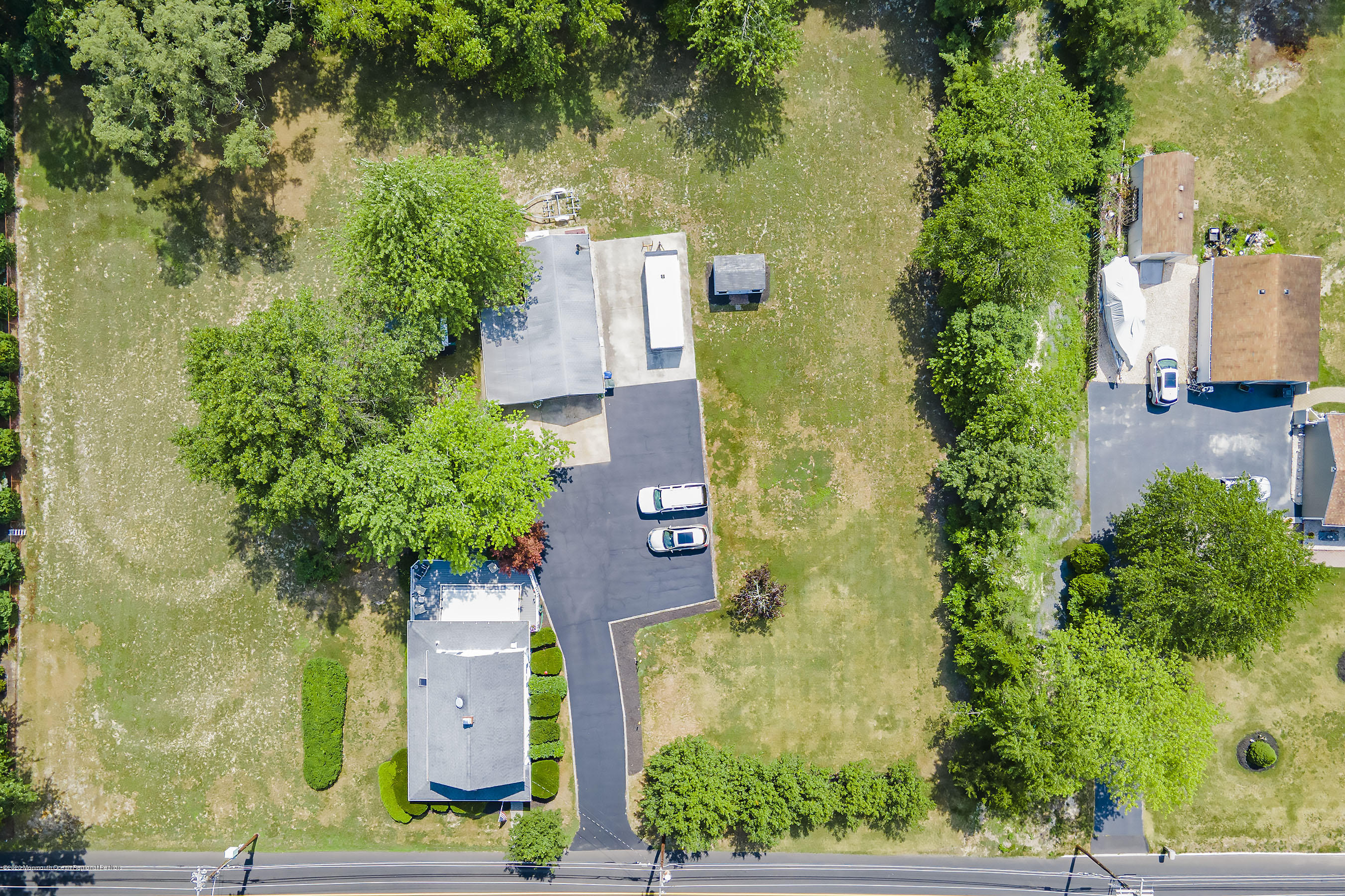 7 Wooleytown Road Morganville, NJ 07751 - Photo 29 of 30 an aerial view of a house with a yard and lake view