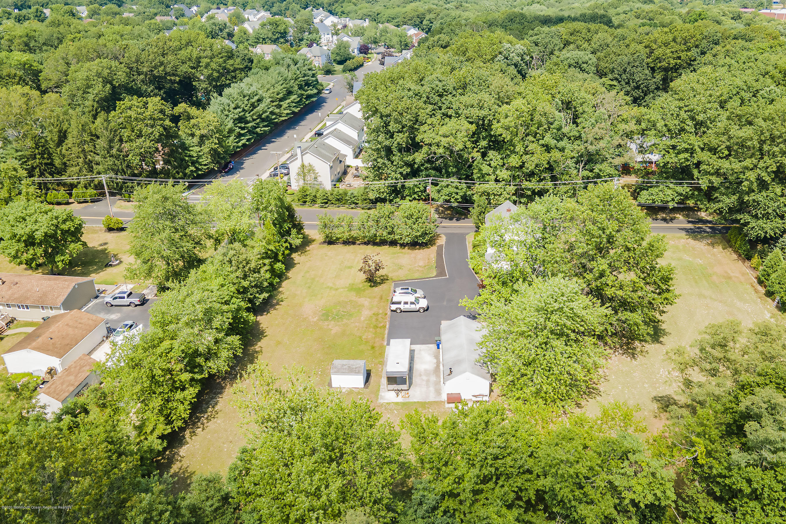 7 Wooleytown Road Morganville, NJ 07751 - Photo 30 of 30 an aerial view of a house with a yard and lake view