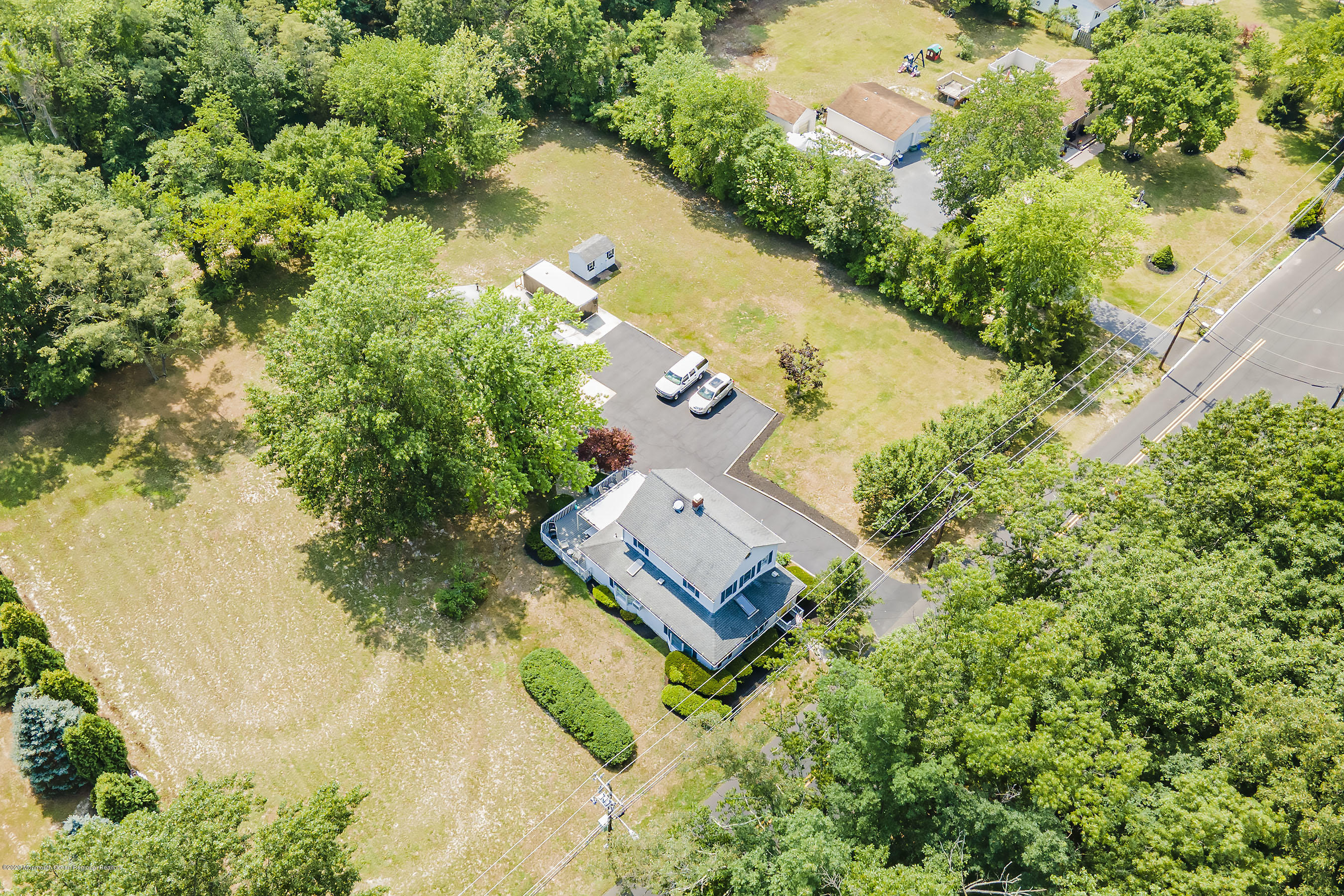 7 Wooleytown Road Morganville, NJ 07751 - Photo 3 of 30 an aerial view of a house with a yard and lake view