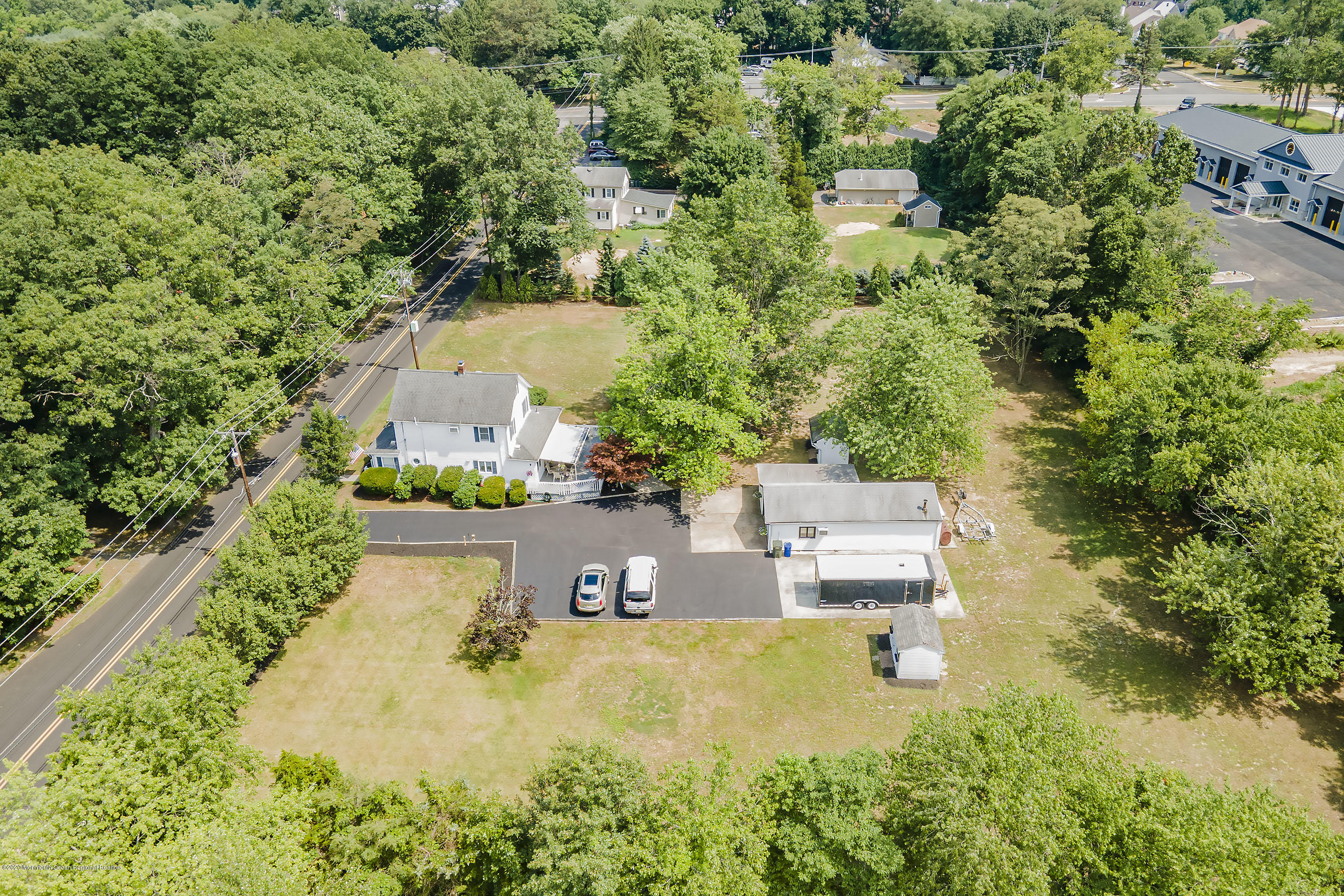 7 Wooleytown Road Morganville, NJ 07751 - Photo 4 of 30 an aerial view of a house with a yard and lake view