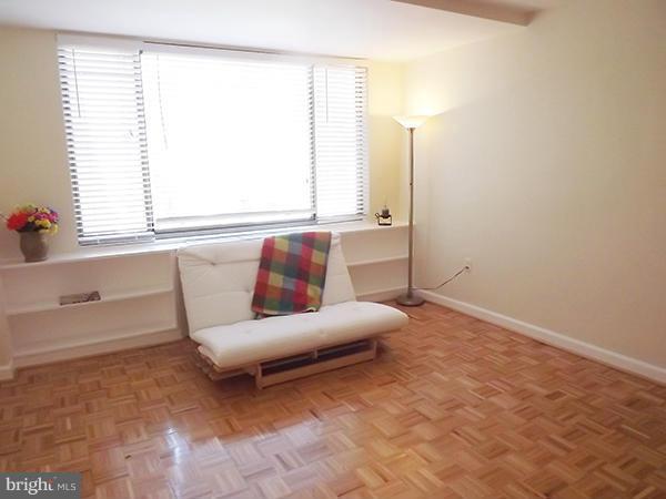1111 Arlington Boulevard, Unit 437 Arlington, VA 22209 - Photo 4 of 14 a living room with furniture and a window