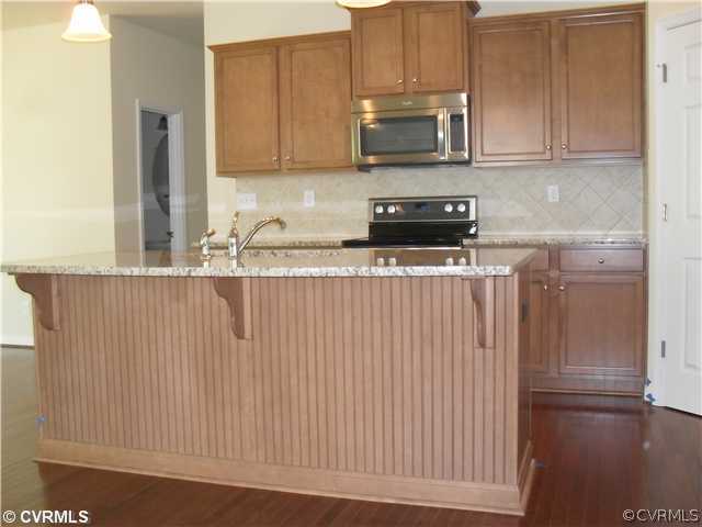 12001 Winterpock Road Chesterfield, VA 23838 - Photo 2 of 6 a kitchen with stainless steel appliances granite countertop a stove a sink and a microwave