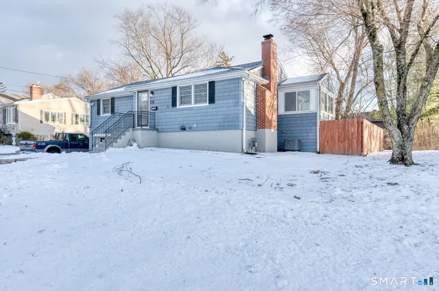 a view of a house with a snow in front of it