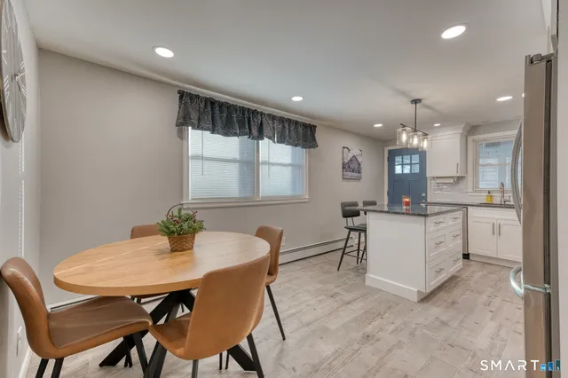 a kitchen with a table and chairs in it