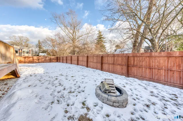 a view of a backyard with wooden fence