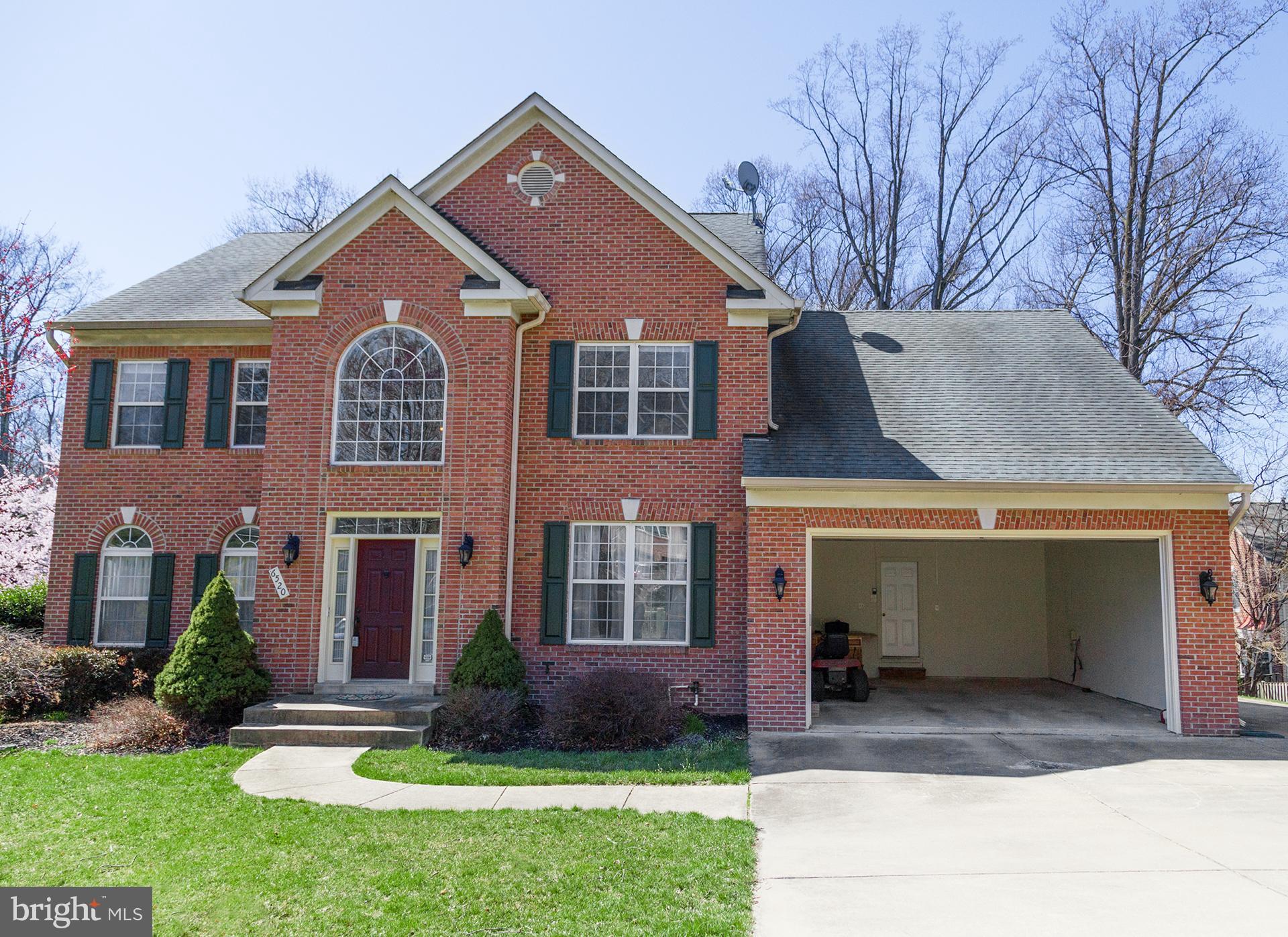 6520 Wren Drive Springfield, VA 22150 - Photo 1 of 2 a front view of a house with a yard and garage