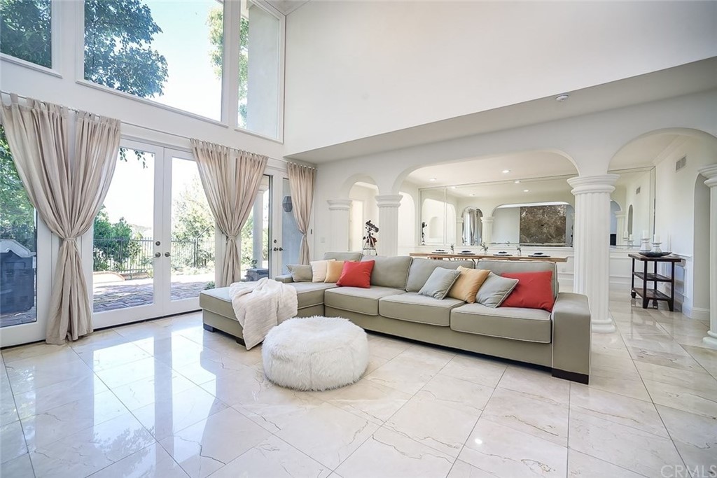 12373 Ridge Circle Los Angeles, CA 90049 - Photo 1 of 1 a living room with furniture and a large window
