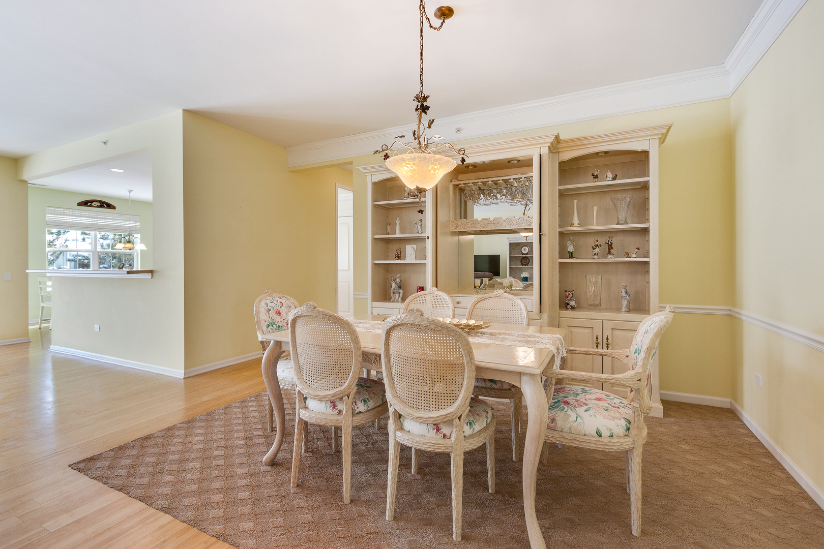 12614 Raintree Path Huntley, IL 60142 - Photo 15 of 28 a dining room with furniture a chandelier and wooden floor