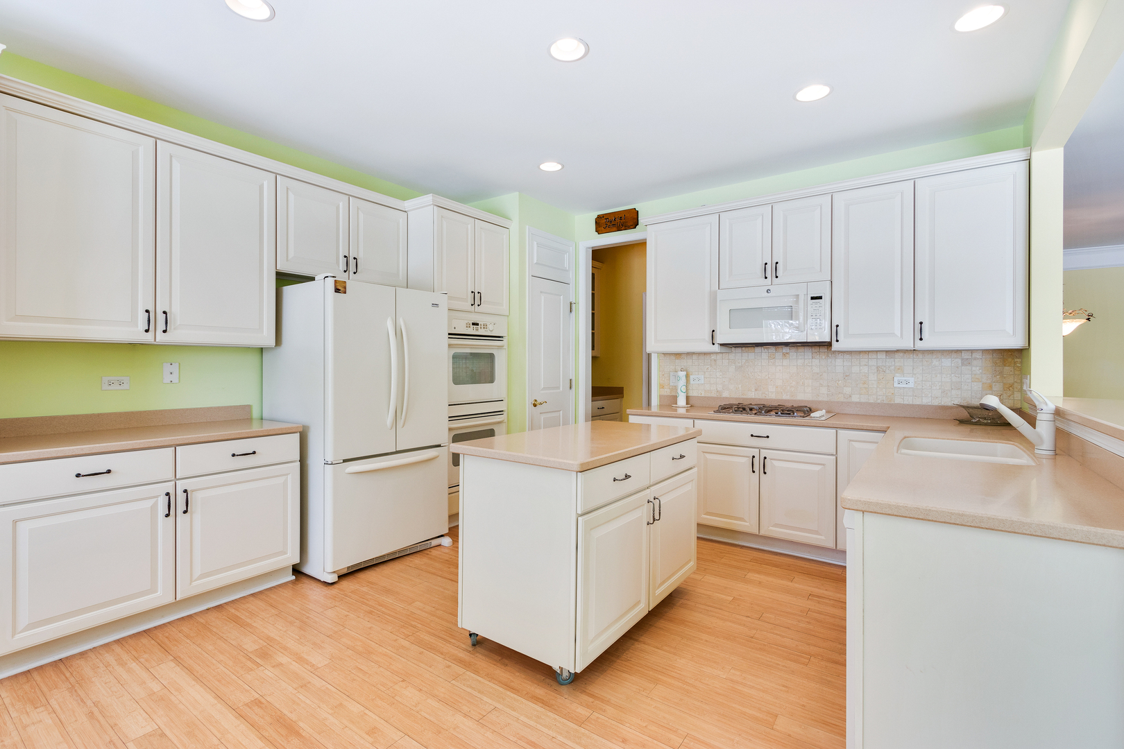 12614 Raintree Path Huntley, IL 60142 - Photo 5 of 28 a kitchen with white cabinets and white appliances