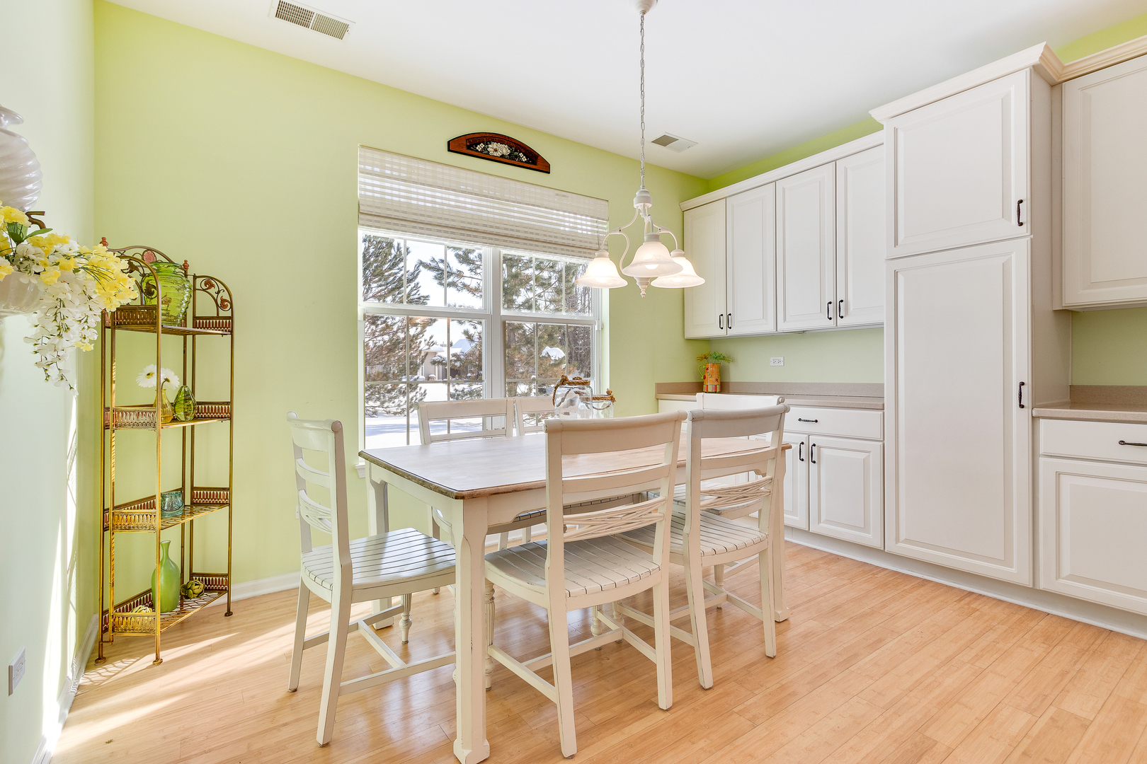 12614 Raintree Path Huntley, IL 60142 - Photo 9 of 28 a kitchen with a table chairs refrigerator and cabinets