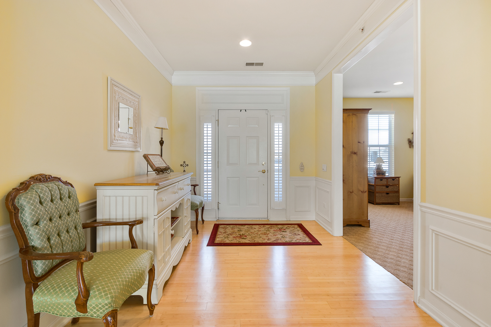 12614 Raintree Path Huntley, IL 60142 - Photo 10 of 28 a hallway with dining area and chandelier