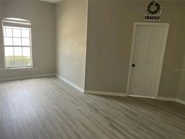 a white toilet sitting next to a small window