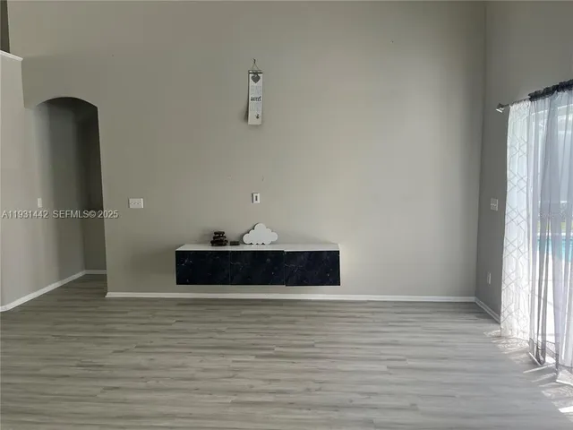 a view of a room with wooden floor