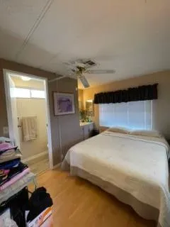 a bedroom with a bed and a window