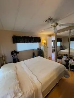a bedroom with a bed and a large mirror