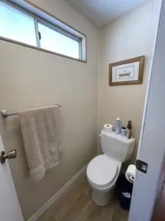 a white toilet sitting next to a sink