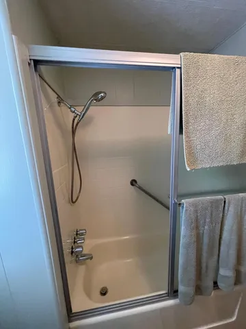 a bathroom with a glass shower door