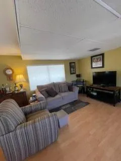 a living room with furniture a couch and a flat screen tv