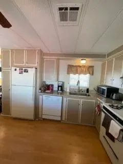 a kitchen with refrigerator and microwave