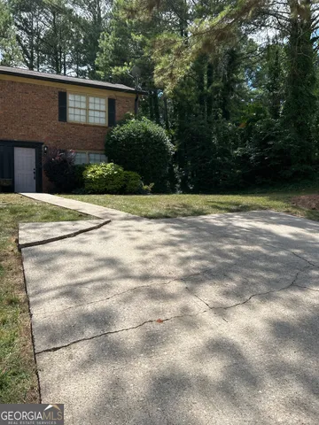 a view of a house with a yard and garage