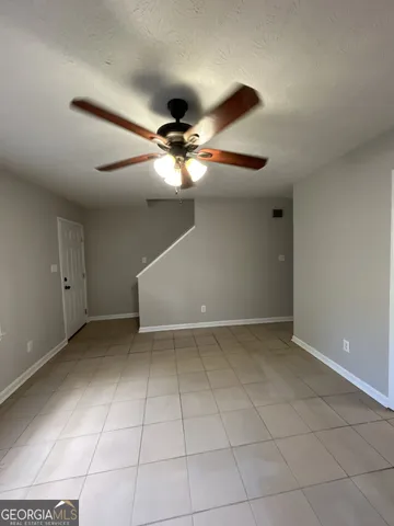 a view of an empty room with a fan