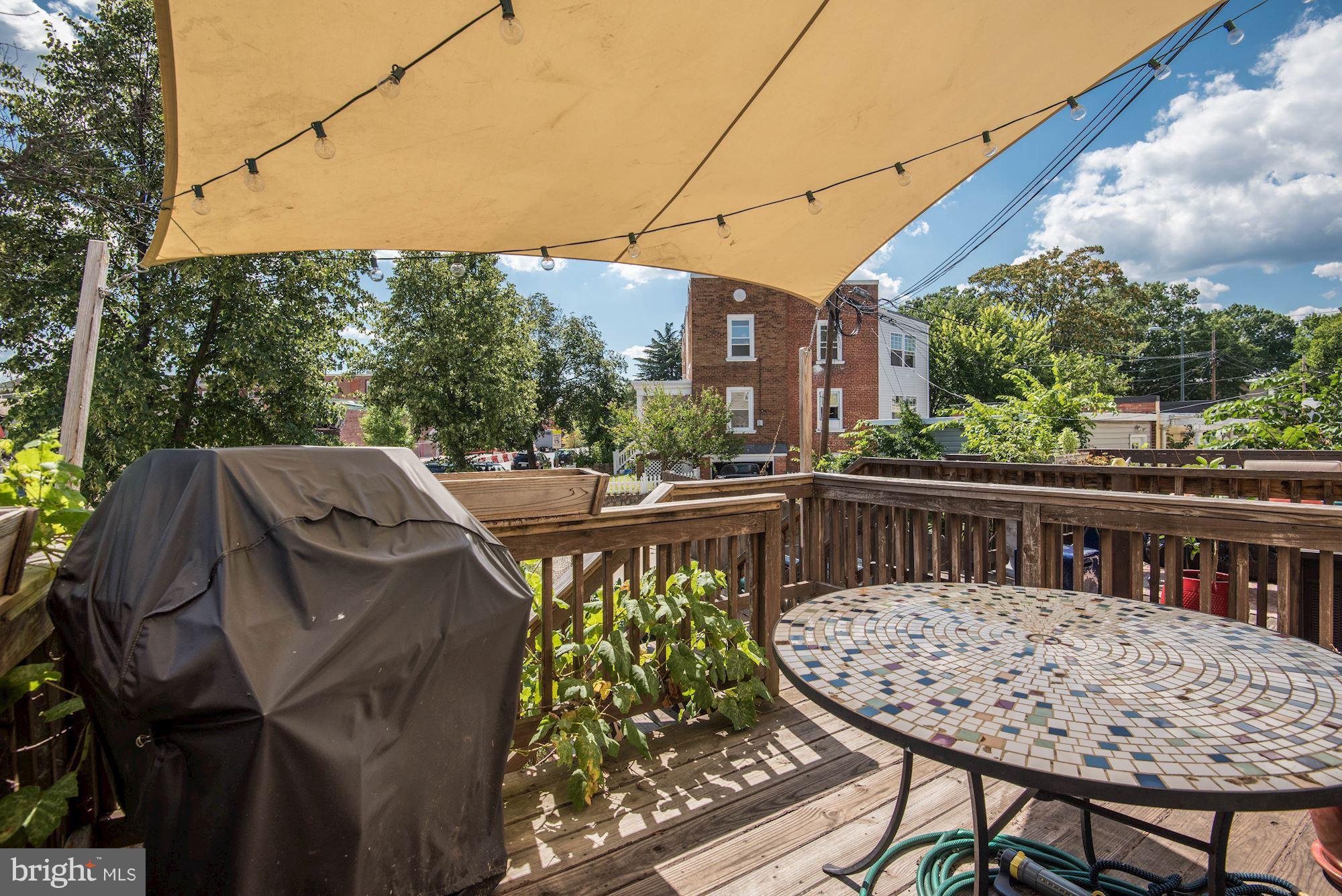 349 Kentucky Avenue Southeast Washington, DC 20003 - Photo 27 of 29 a view of a roof deck with table and chairs under an umbrella