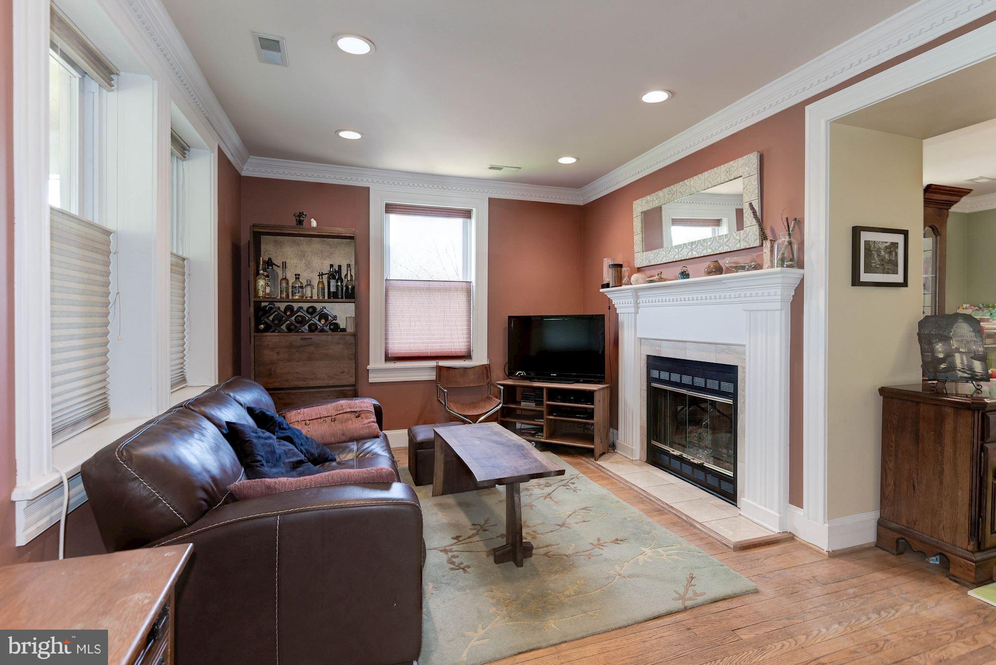 349 Kentucky Avenue Southeast Washington, DC 20003 - Photo 5 of 29 a living room with furniture a flat screen tv and a fireplace