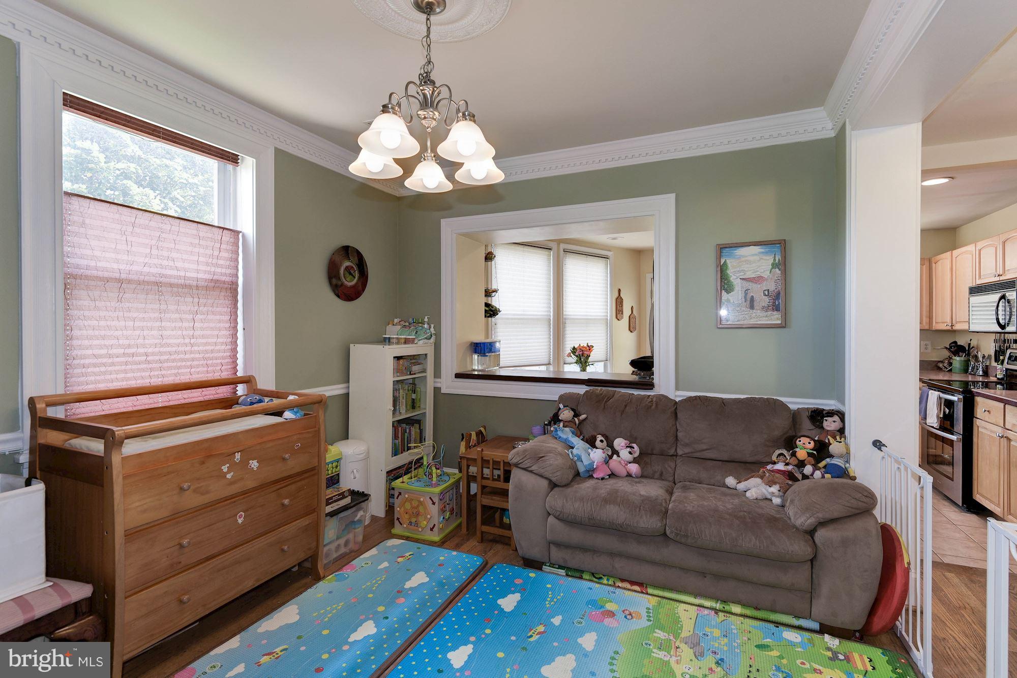 349 Kentucky Avenue Southeast Washington, DC 20003 - Photo 6 of 29 a living room with furniture and a chandelier