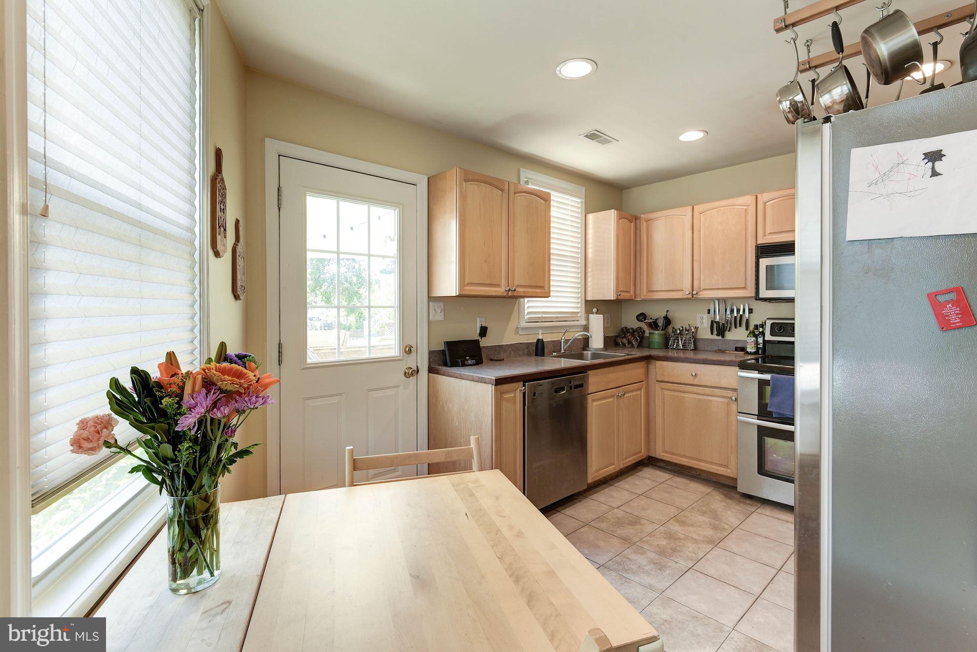 349 Kentucky Avenue Southeast Washington, DC 20003 - Photo 8 of 29 a kitchen with a refrigerator a sink and cabinets