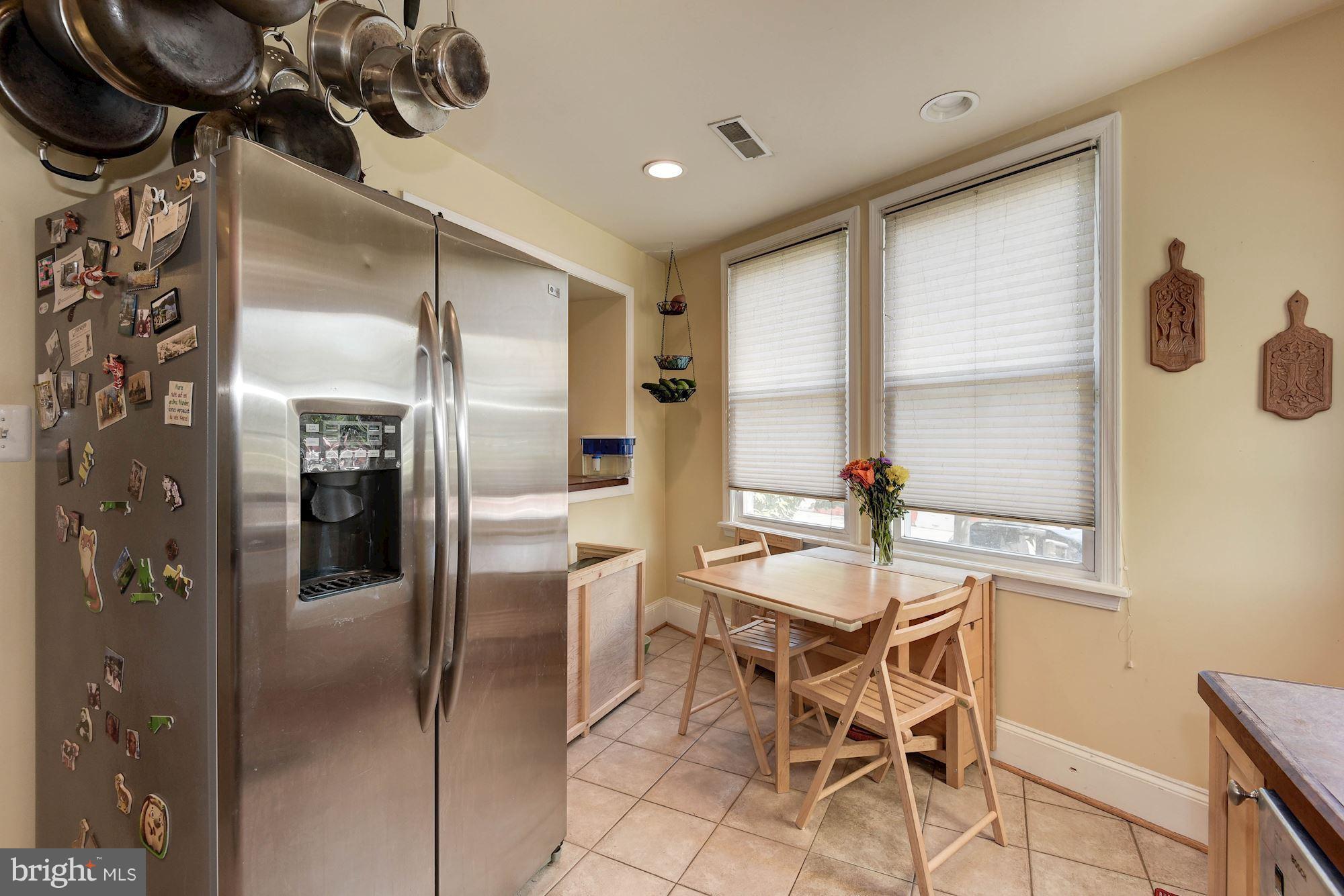 349 Kentucky Avenue Southeast Washington, DC 20003 - Photo 10 of 29 a dining room with stainless steel appliances kitchen island granite countertop furniture and a refrigerator