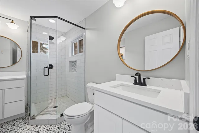 a bathroom with a sink a toilet and a mirror