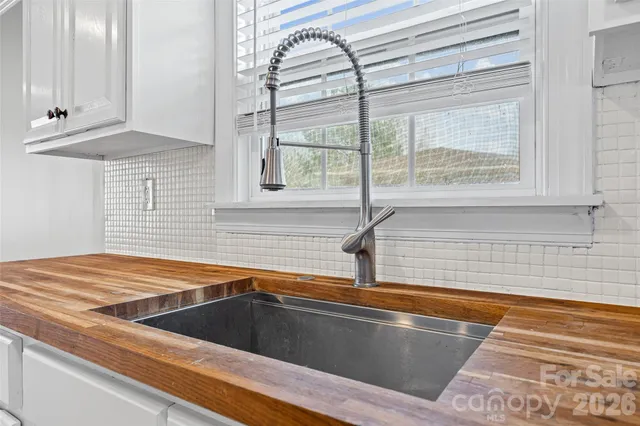 a view of a kitchen sink and a window