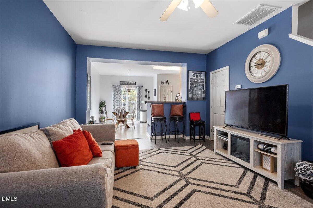1409 Oxleymare Drive Raleigh, NC 27610 - Photo 11 of 28 a living room with furniture and a flat screen tv