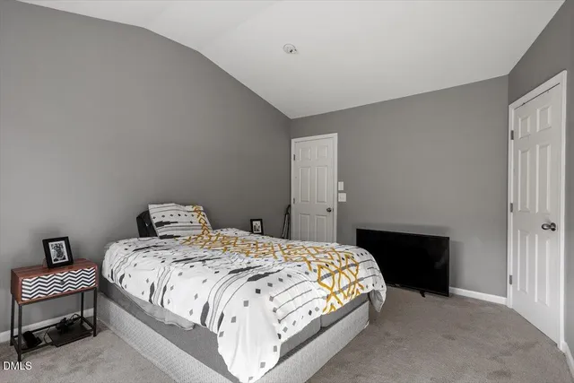 a bedroom with a bed and a table