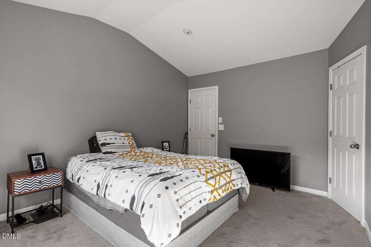 1409 Oxleymare Drive Raleigh, NC 27610 - Photo 23 of 28 a bedroom with a bed and a table