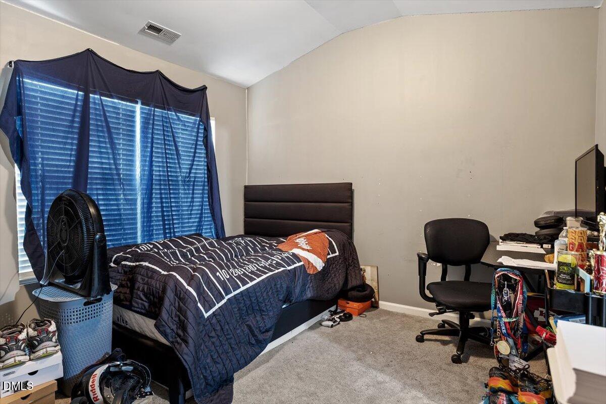 1409 Oxleymare Drive Raleigh, NC 27610 - Photo 27 of 28 a bedroom with a bed and a desk