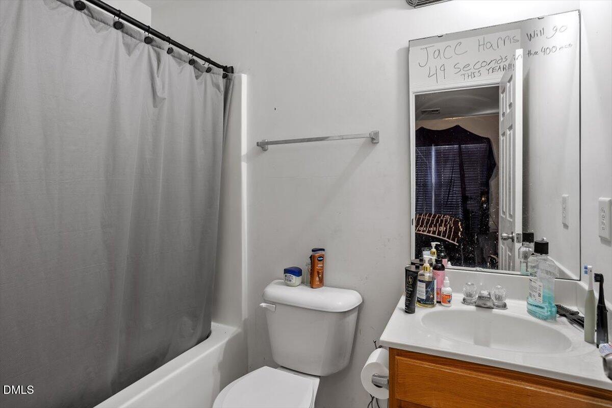 1409 Oxleymare Drive Raleigh, NC 27610 - Photo 28 of 28 a bathroom with a sink and a mirror