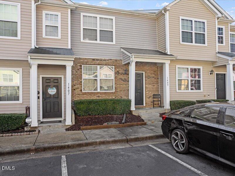 1409 Oxleymare Drive Raleigh, NC 27610 - Photo 3 of 28 a car parked in front of a building