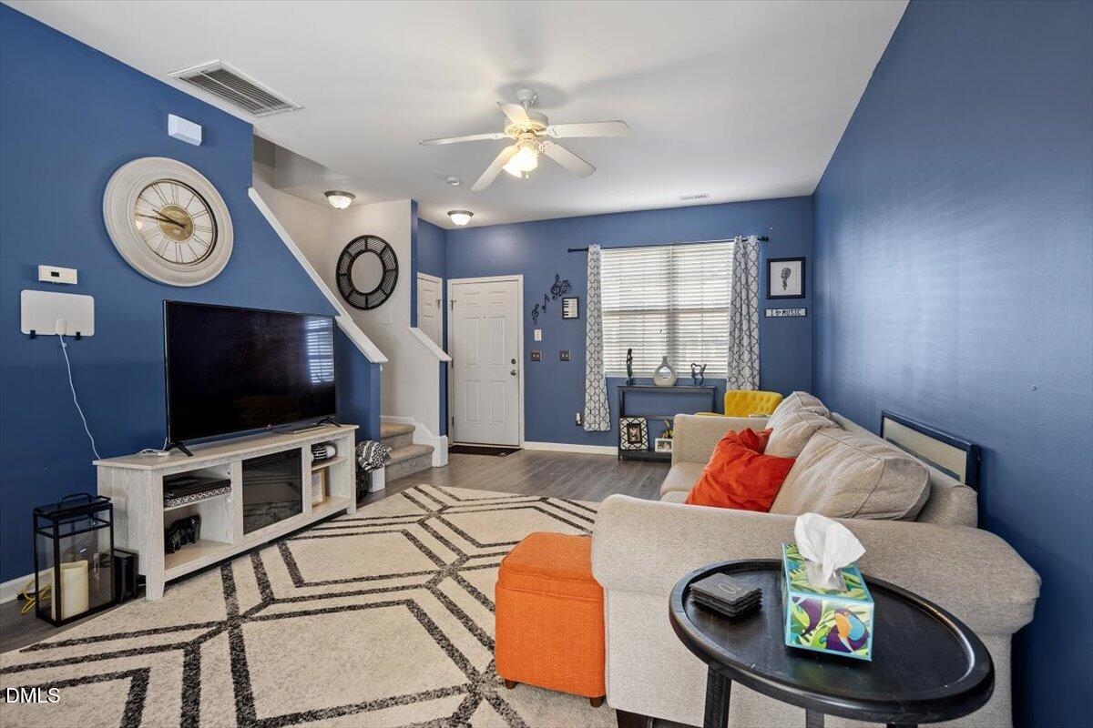1409 Oxleymare Drive Raleigh, NC 27610 - Photo 9 of 28 a living room with furniture and a flat screen tv