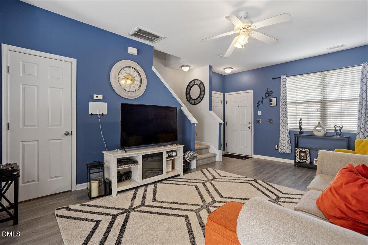 1409 Oxleymare Drive Raleigh, NC 27610 - Photo 10 of 28 a living room with furniture a flat screen tv and a large window