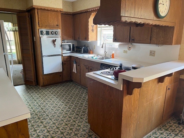 8639 Cedarbrake Drive Spring Valley Village, TX 77055 - Photo 5 of 26 This inviting kitchen features a convenient breakfast bar with a built-in cooktop and sleek double ovens, perfect for culinary enthusiasts.