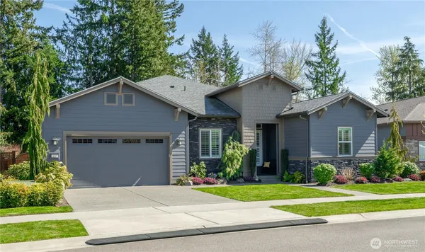 a front view of a house with a yard and garage