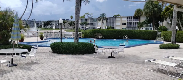 a view of a patio with a table and chairs
