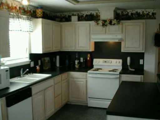 a kitchen with a cabinets and white appliances
