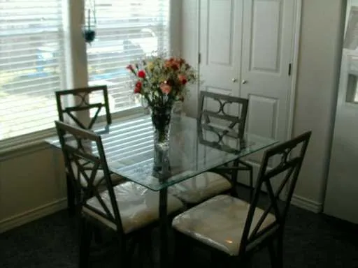 a view of a dining room with furniture and window