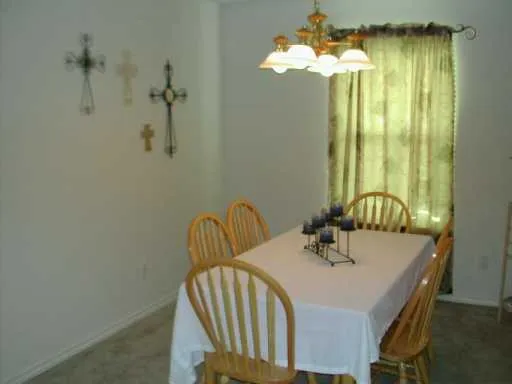 a view of a dining room with furniture and chandelier